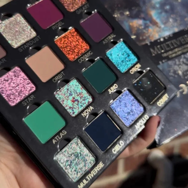 Multichrome magnetic eyeshadow palette held in hand, showing purple, orange, teal, green, and blue
