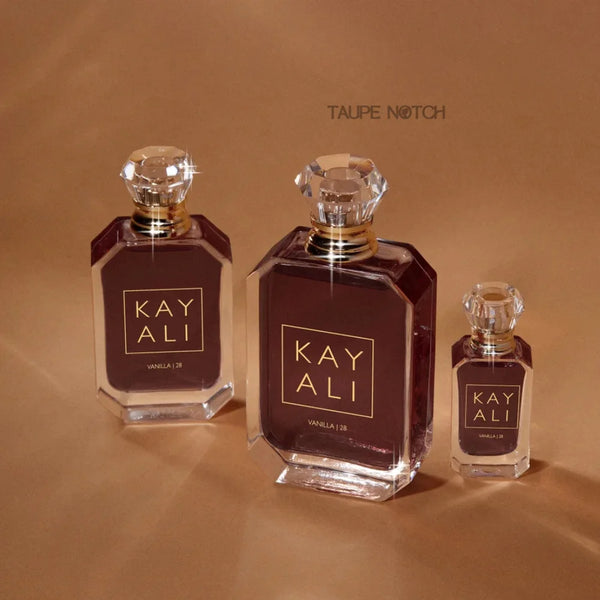 Kayali Vanilla 28 eau de parfum set: three dark-maroon bottles with gold caps