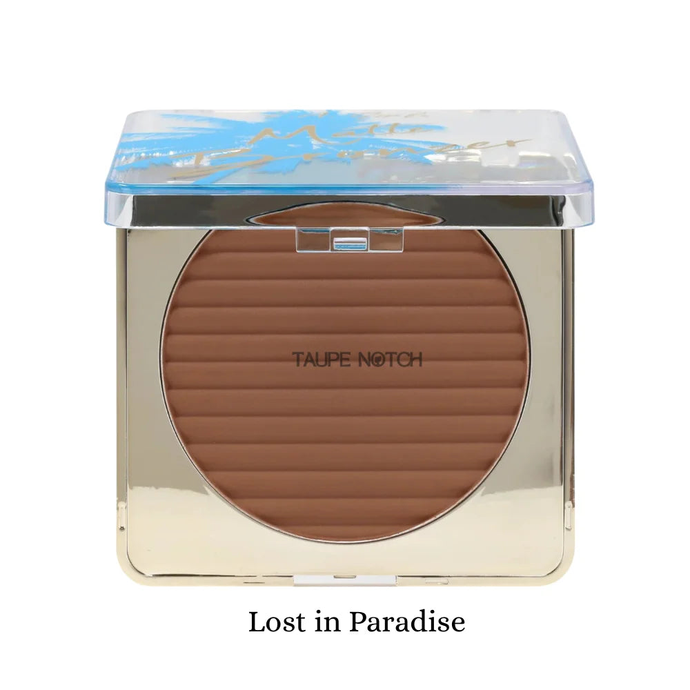 Matte bronzer compact in Lost in Paradise shade, showing a taupe-brown pan with ridges