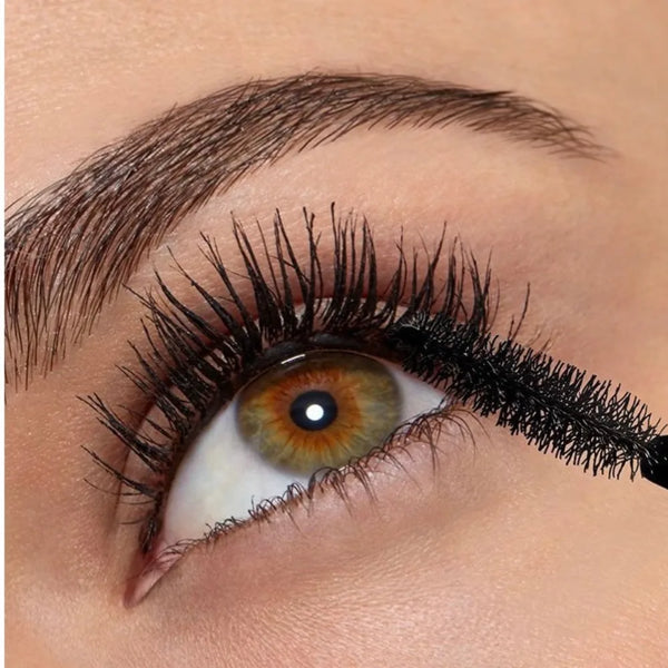 Volumizing mascara effect on eye with thick dark lashes