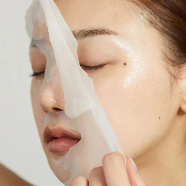 Person applying a face mask with a white background