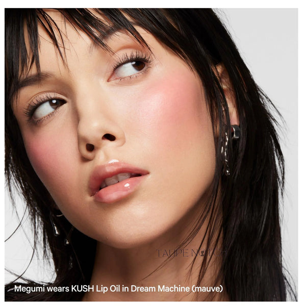 Sheer mauve lip oil with glossy finish on lips