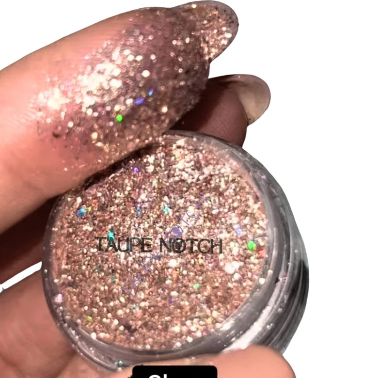 Taupe glitter compact with starry multicolor sparkle and clear cover, close-up