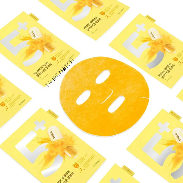 Orange face mask sheet with eye openings, surrounded by yellow No.5 packets