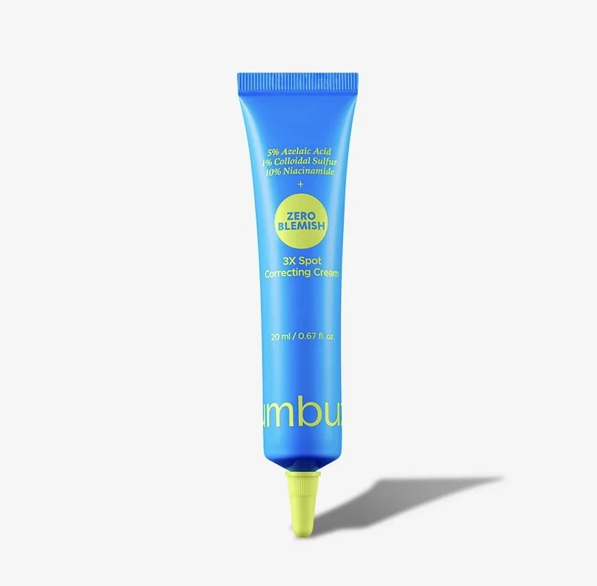 A blue squeeze tube of numbuzin Zero Blemish 3X Spot Correcting Cream with a bright yellow applicator tip, set against a clean white background with a soft shadow.