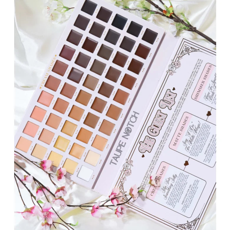 Makeup palette open with multiple square eyeshadow shades in a neat grid and guide card