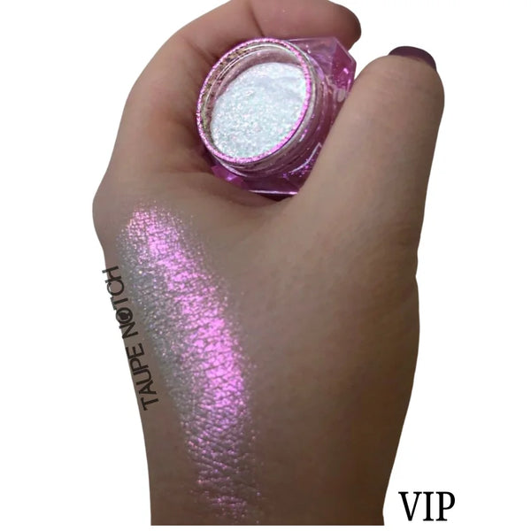 Starry glitter makeup jar with taupe shimmer swatch on hand
