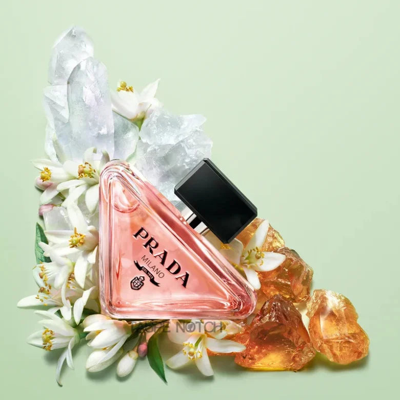 Eau de parfum bottle with flowers and amber crystals, black cap