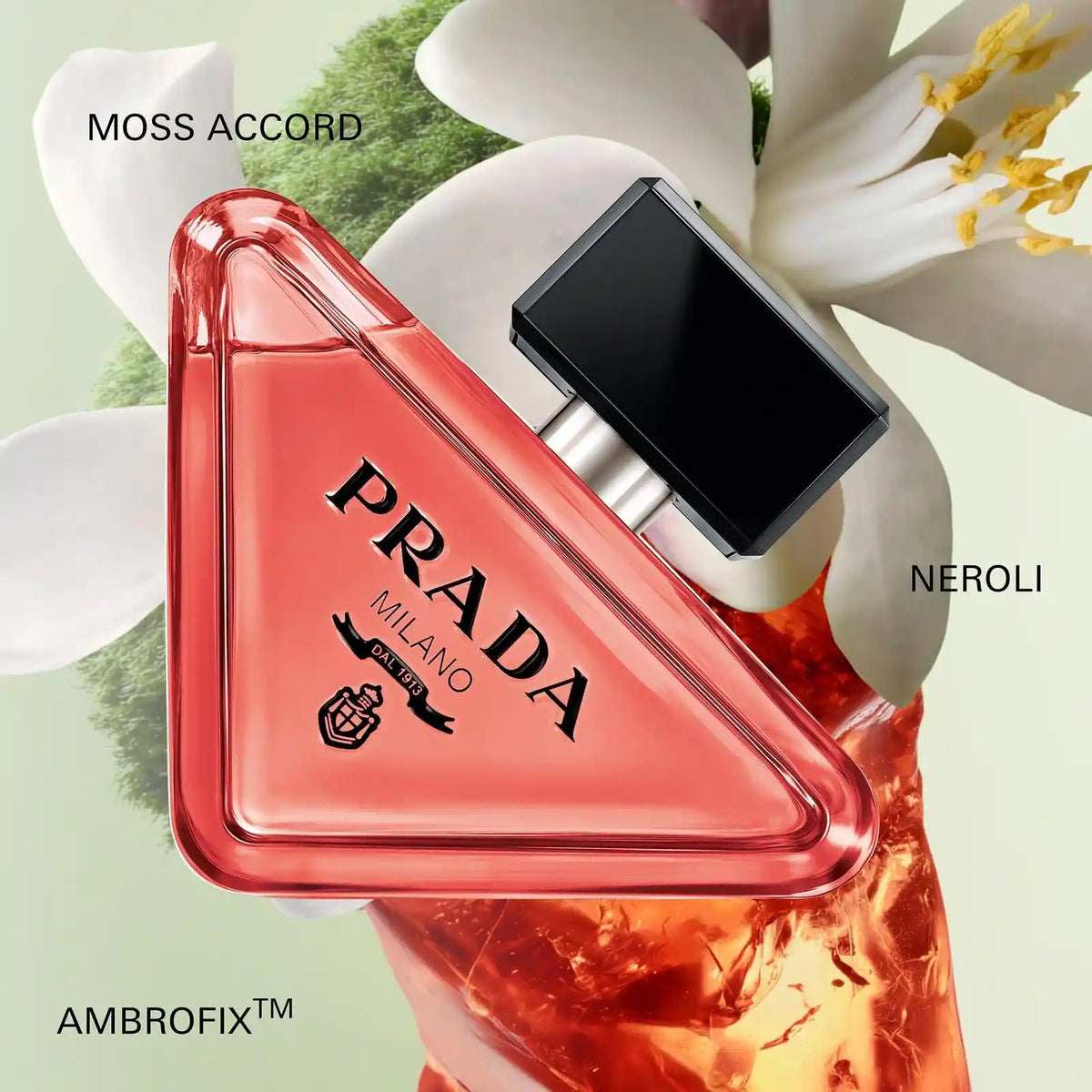 Triangular red-pink eau de parfum bottle with black cap