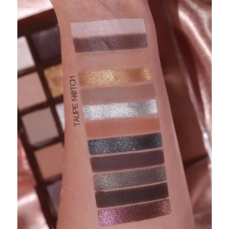 Eye shadow swatches on skin: taupe, gold, pale pink, light gray, dark brown, and purple