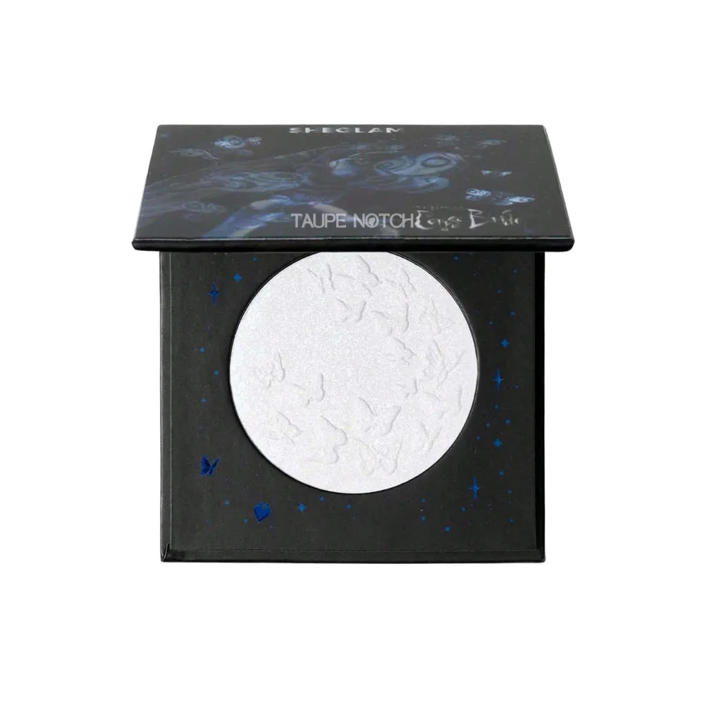 Butterfly-themed highlighter compact with circular pale blue shimmer pan and black cover
