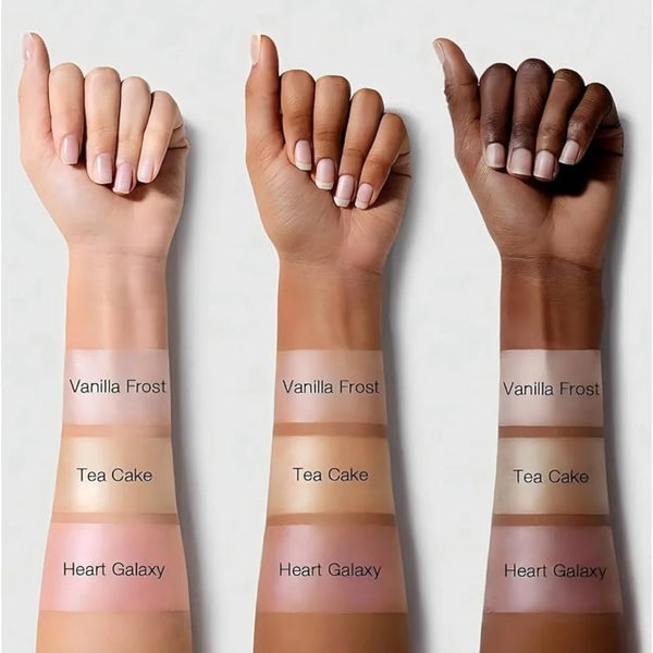 Highlighter shade swatches on forearms: Vanilla Frost, Tea Cake, Heart Galaxy