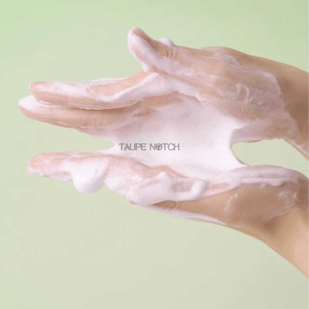 Foam cleanser lather in hands, thick white bubbles for cleansing