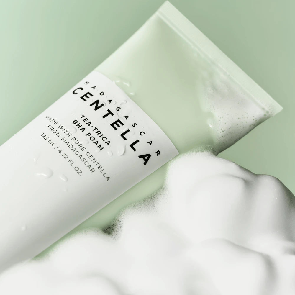 Foam cleanser tube dispensing white lather, with Madagascar Centella Tea-Trica label