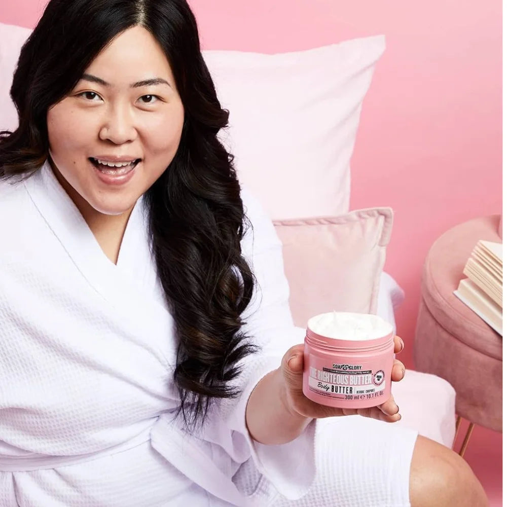 Pink body butter jar held in hand, 300 ml label facing forward
