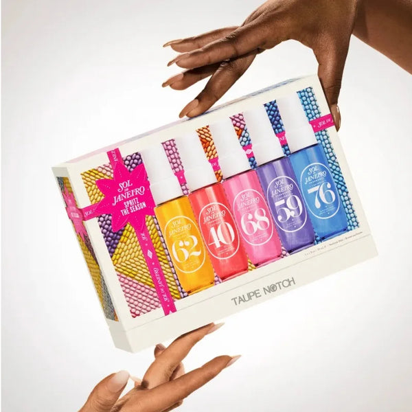 Sol de Janeiro gift set box held in hands, showing six mini mist bottles in bright colors