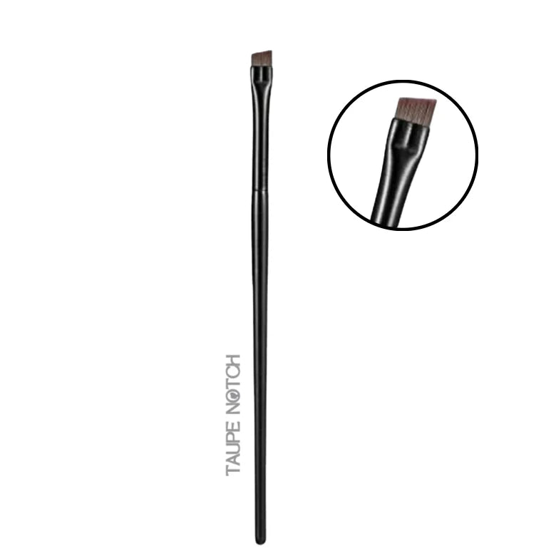 Eyebrow and eyeliner brush with dark handle and angled bristles, top view