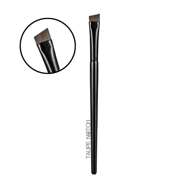 Eyebrow and eyeliner brush with dark handle and angled bristles, close-up
