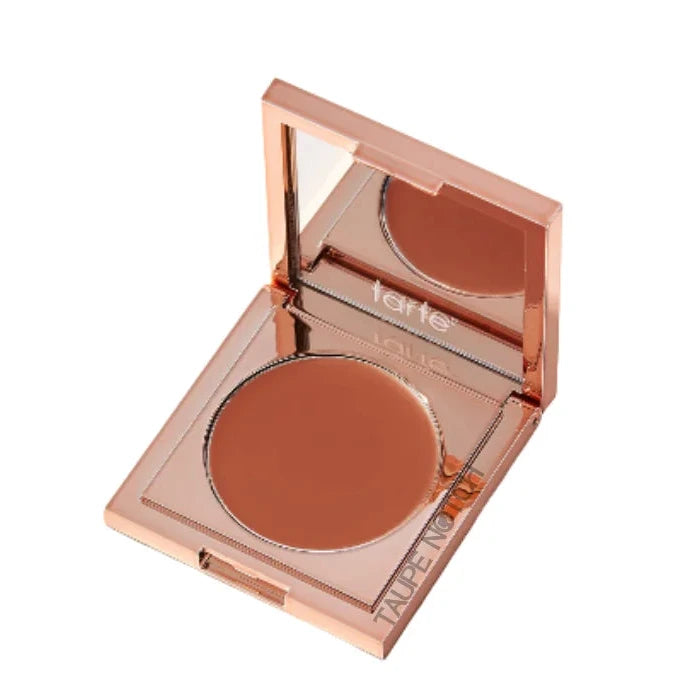 Undereye corrector compact with orange-brown round pan and protective lid