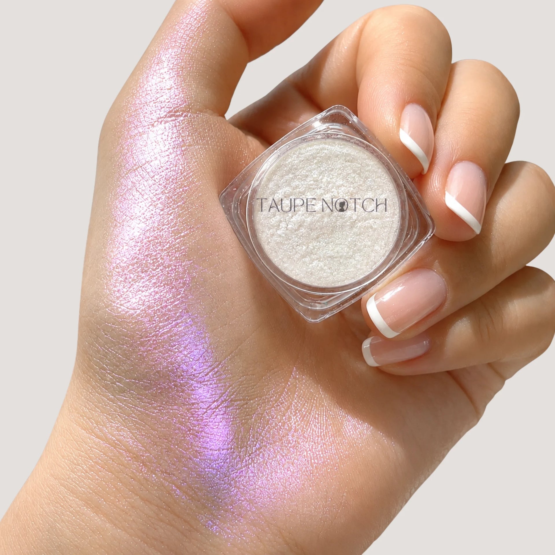 Taupe Notch loose highlighter pigment swatch with shimmering finish on skin