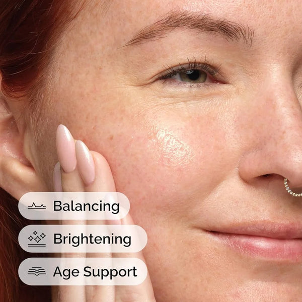 Vitamin C serum applied to face near cheek and eye, fingertips close-up
