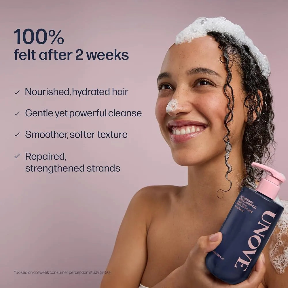 Deep damage repair shampoo bottle held by smiling person, dark navy with pink pump
