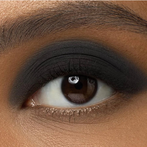 Dark smoky eyeshadow on eyelid with defined crease and brown eye