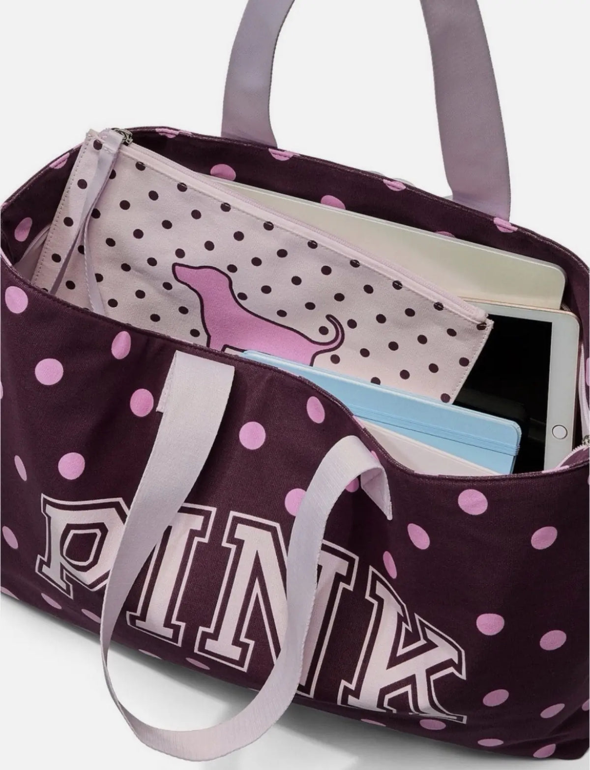 Polka dot tote bag open with wristlet pouch inside, light purple dotted lining
