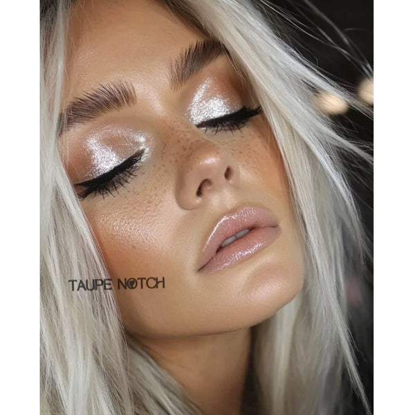 Taupe glitter eyeshadow on eyelids with sharp winged eyeliner