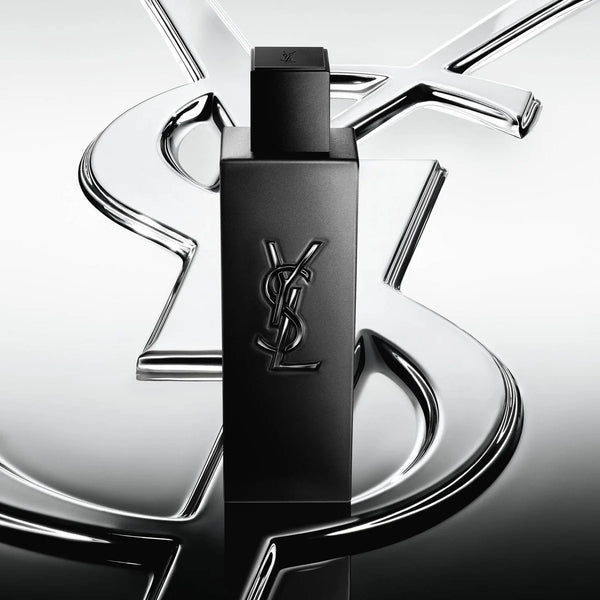 Black YSL perfume bottle on a reflective silver background